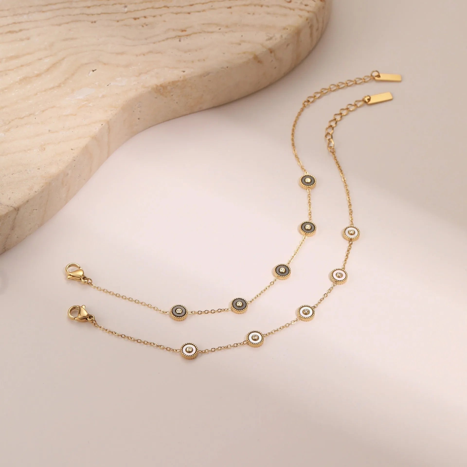 Geometric fritillary design stainless steel bracelet with 18K gold plating and matching necklace