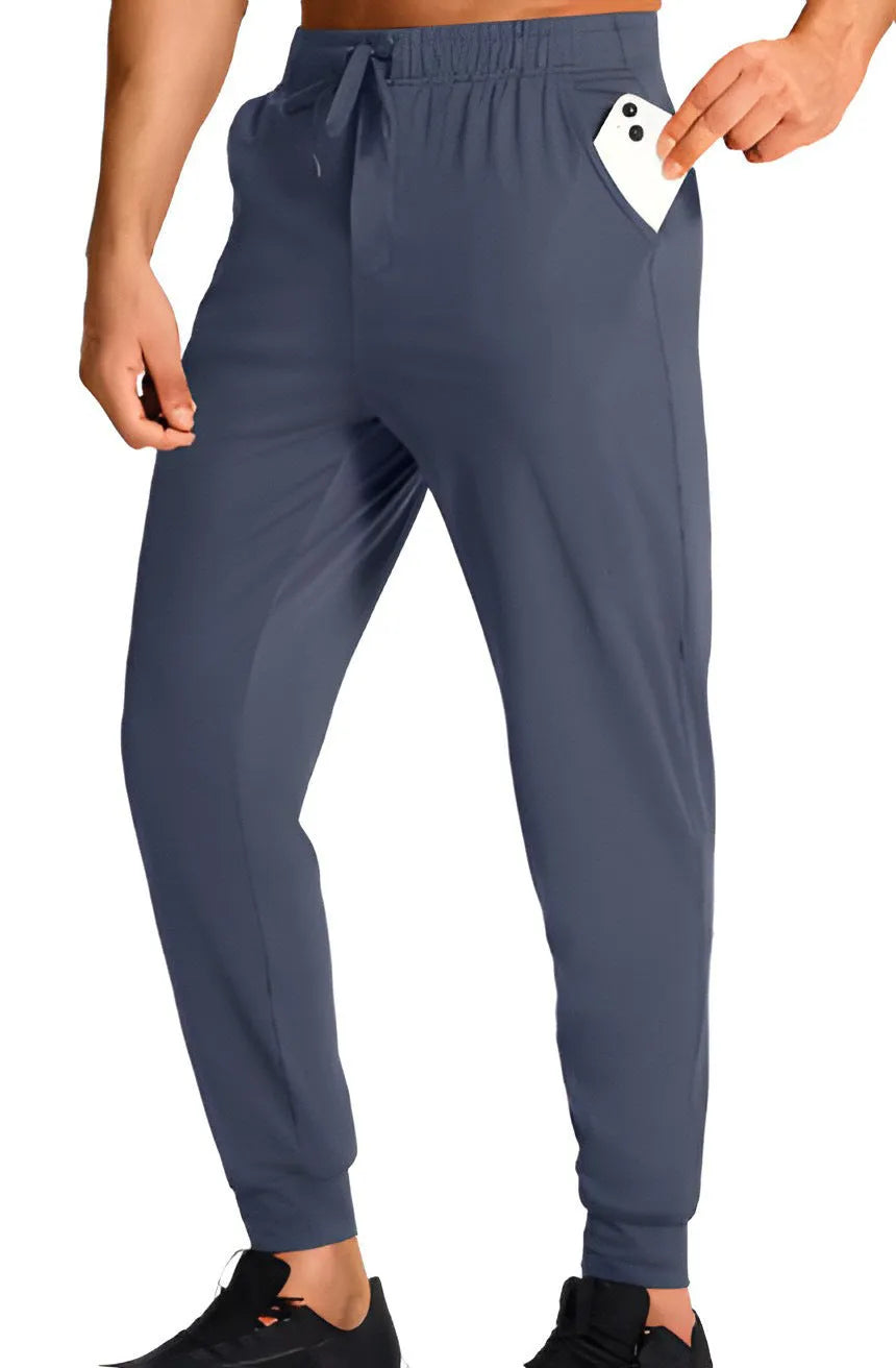 Men's loose-fitting casual polyester trousers in a solid colour on a hanger.
