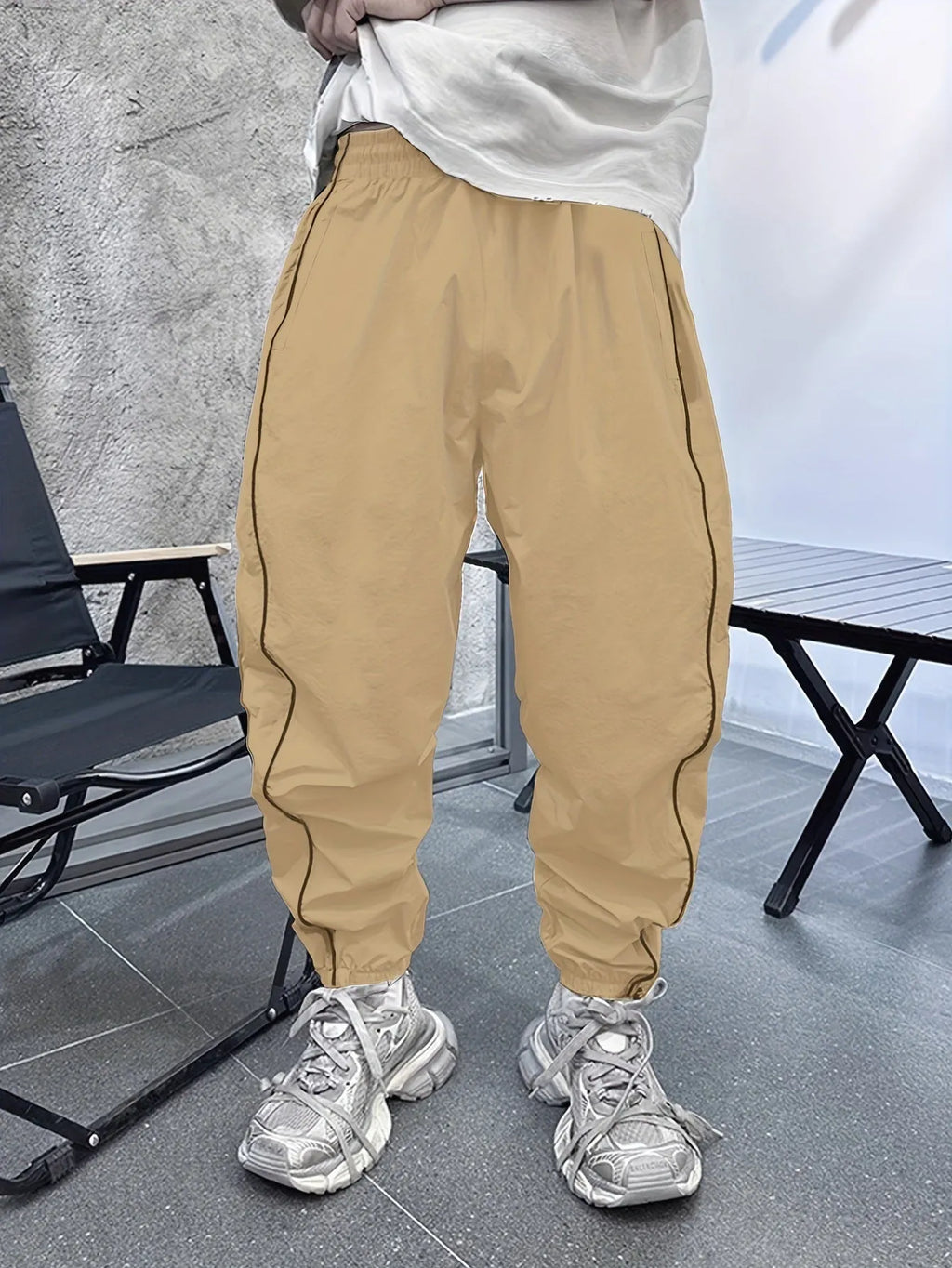 Men's loose blue bamboo fibre cropped sports trousers on a grey background
