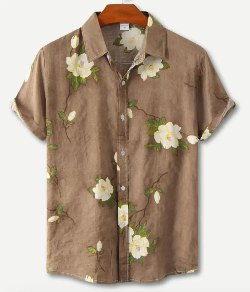 Man wearing a short sleeve lapel collar Hawaiian shirt with a blue floral print.