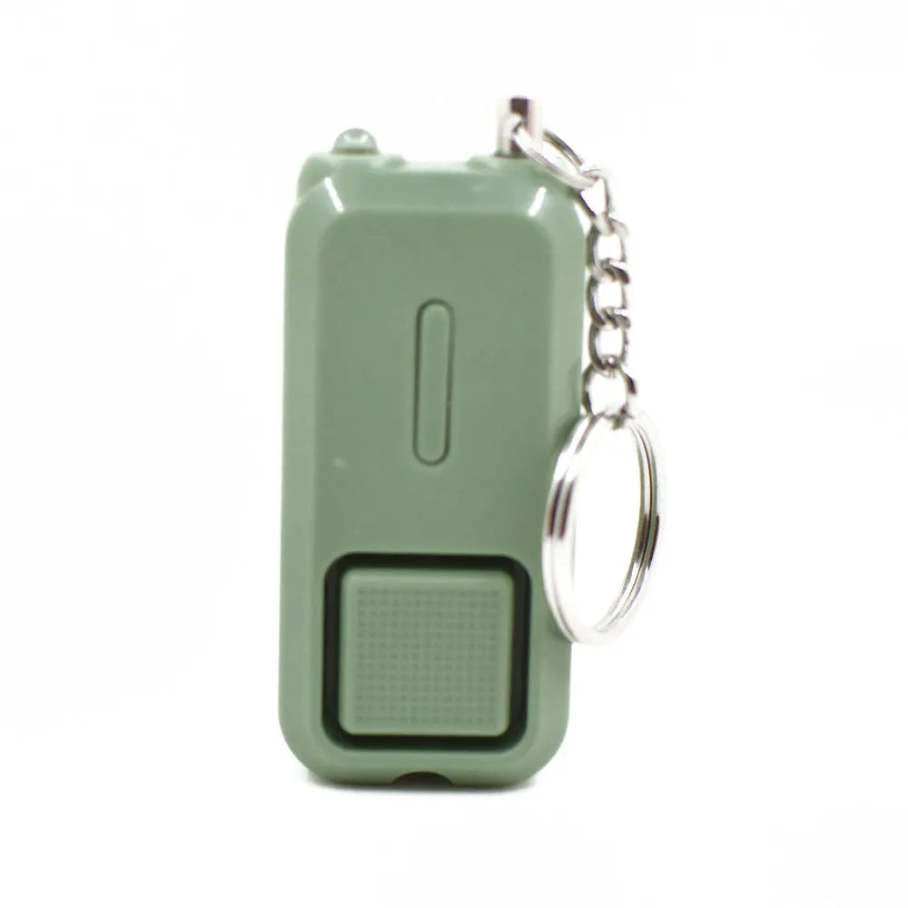 Compact pink personal safety alarm with keyring, showing dimensions next to a ruler.
