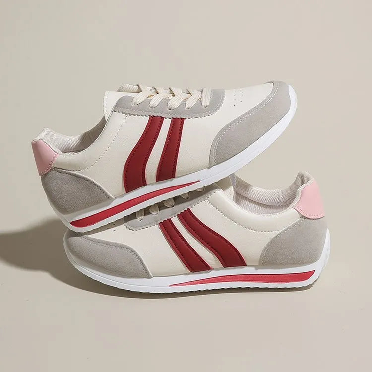 Red and blue low-top lace-up running sneakers on a white background.