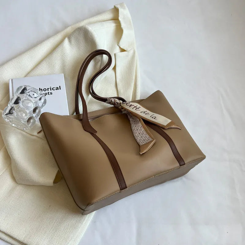 Large casual tote bag with bucket shape showing internal zippered pocket and sewing line detailing