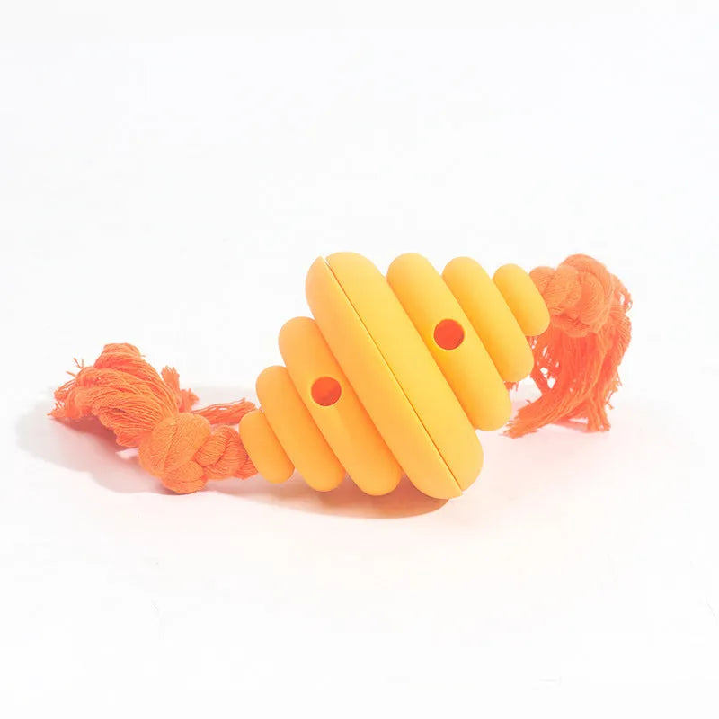 Large green and yellow silicone dog toy with a knotted rope and hollow ball for food dispensing.
