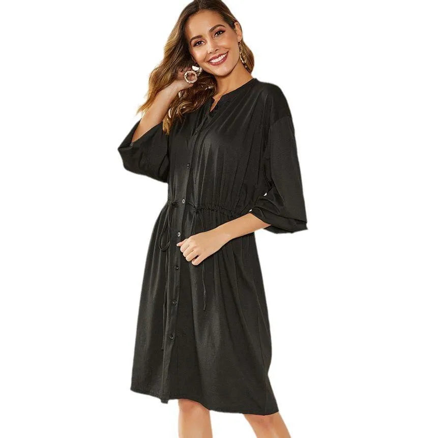 Black loose A-line midi dress with long sleeves, elastic cuffs, and an elasticated waist with a belt.
