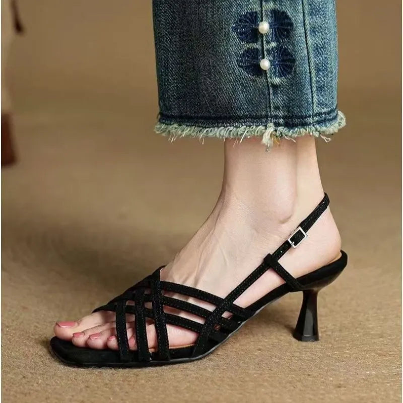 Light brown women's retro sandals with thin cross straps, ankle buckle, and a square toe on a mid heel.