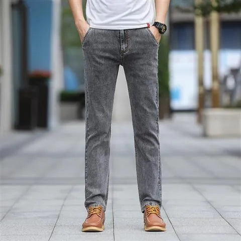 Men's smoky grey autumn jeans with straight tube fit and low waist design on hanger