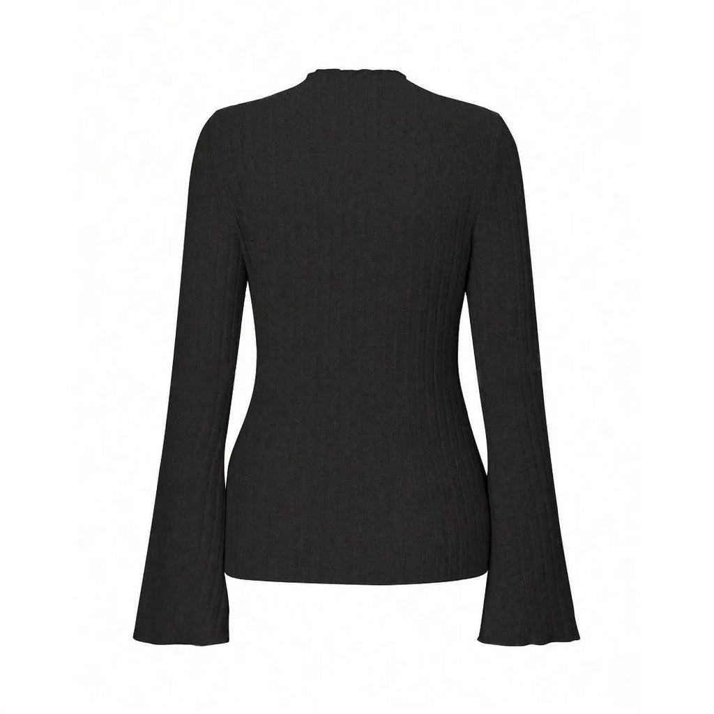 Man wearing a black long sleeve top with a subtle sunken stripe pattern and lantern sleeves.