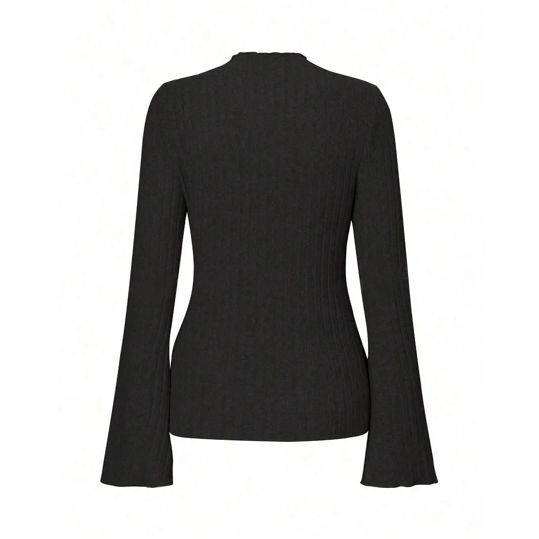 Man wearing a black long sleeve top with a subtle sunken stripe pattern and lantern sleeves.