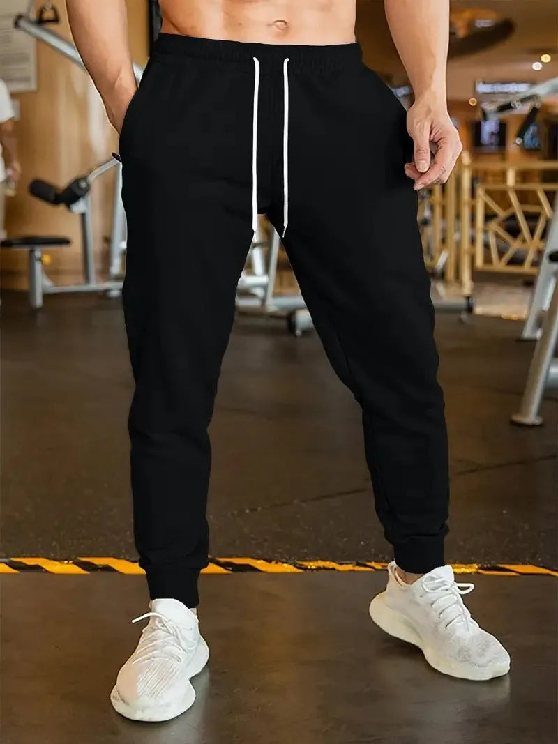 Men's polyester leisure trousers with elastic lace closure and drawstring waist in loose fit design