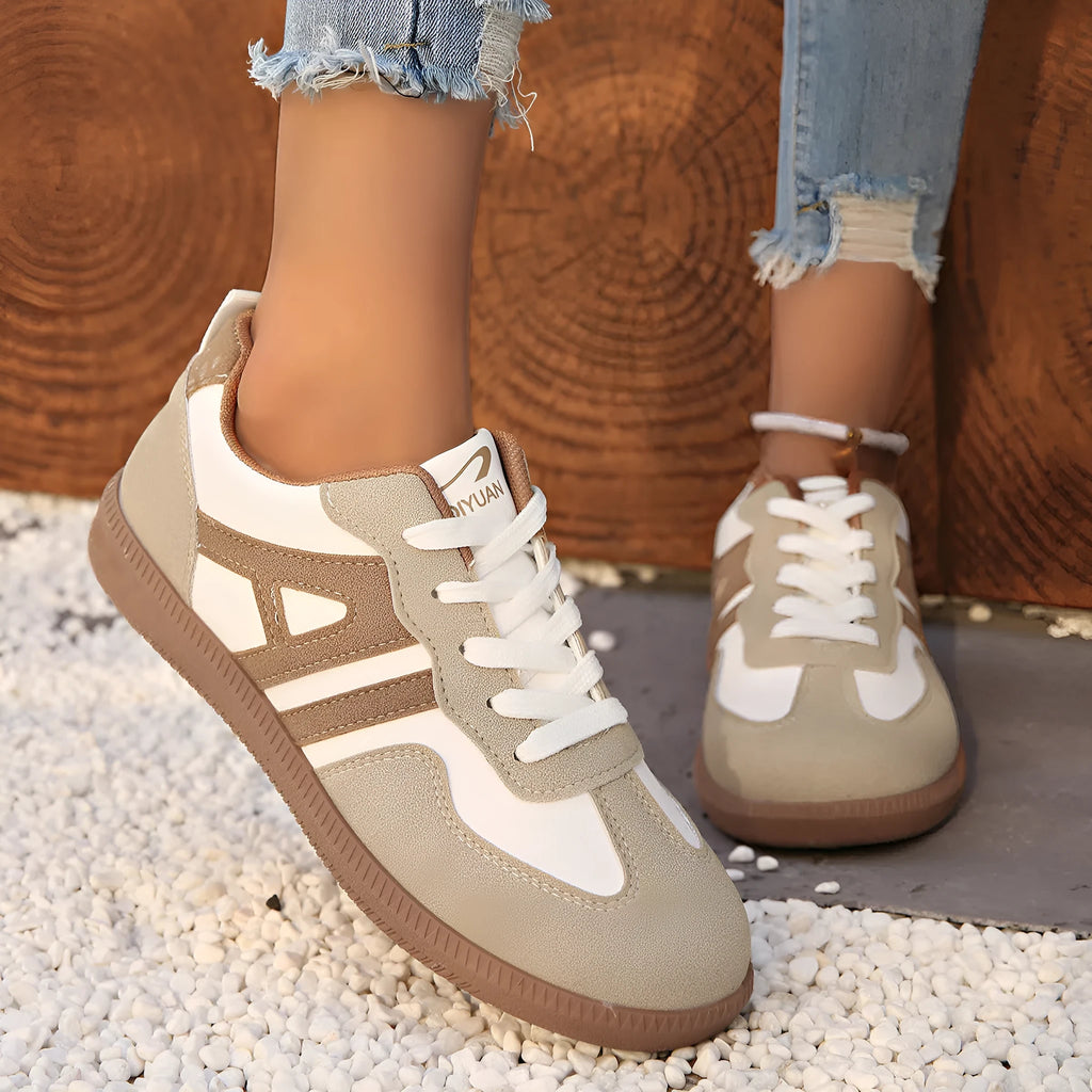 Women's retro grey jogging shoes with lace-up front and cross-strap detail on a rubber platform sole.