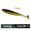 Soft plastic fishing lure in a two-tone colour scheme with a distinctive T-tail, shown alongside a ruler indicating its 7cm length.