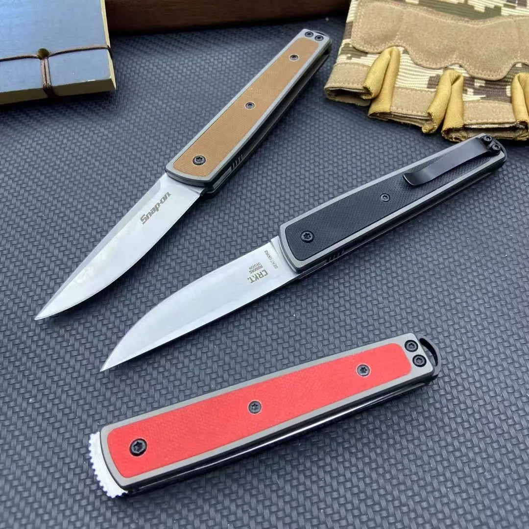 Closed and open views of a folding fruit knife with a coloured handle and stainless steel blade.
