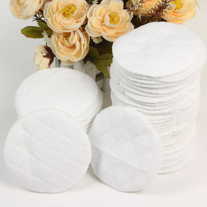 Pack of four white eco-cotton double-layer anti-galactorrhea nursing pads on a white background