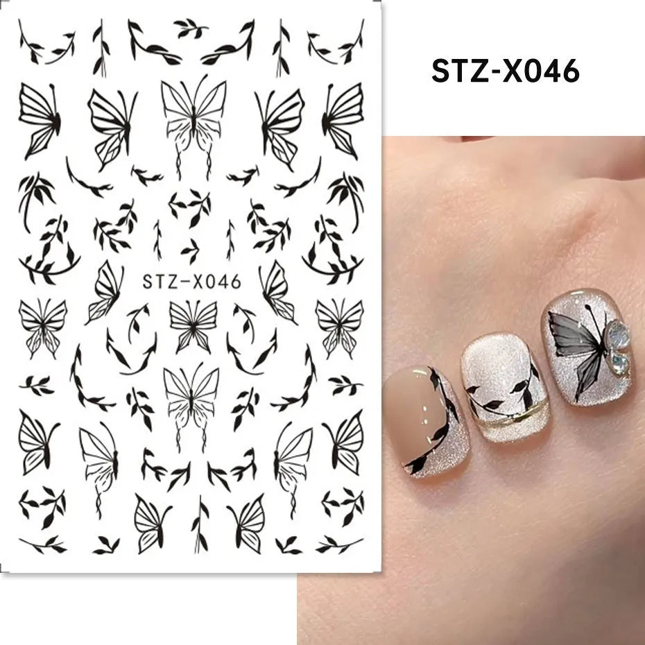 Close-up of a cartoon-style nail sticker with black and silver strips and a love pattern design on a fingernail.