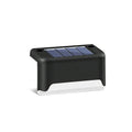 black solar courtyard stair light with ABS body on a garden step