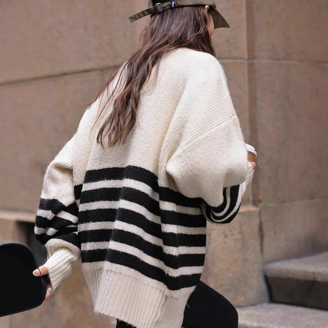 Beige winter maternity sweater with stand collar, loose fit, long sleeves, and striped plaid pattern on a woman