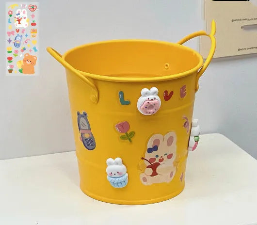 Round metal desktop pen holder in a choice of colours, some with decorative sticker patches.