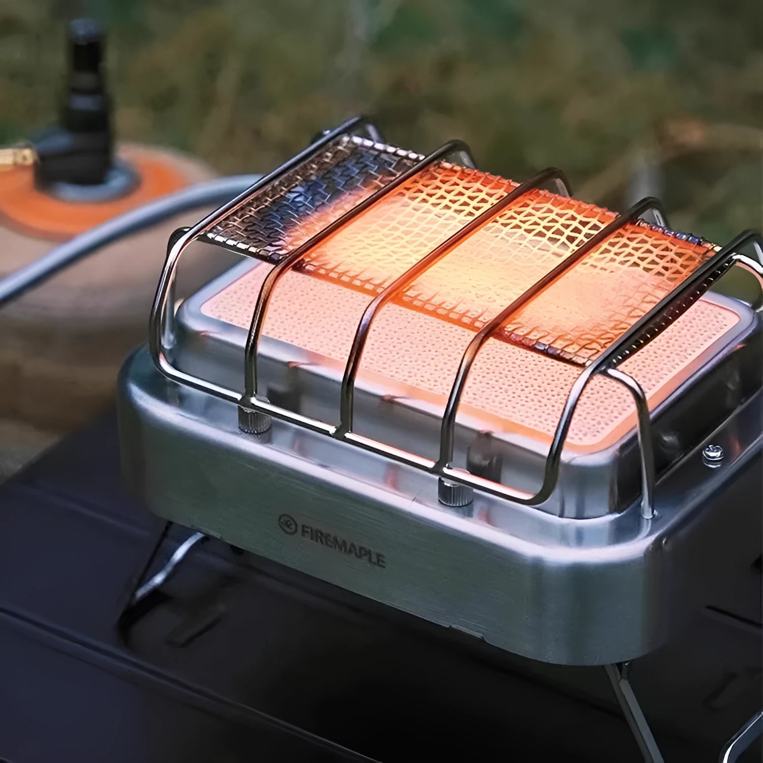 Compact metal outdoor electric heating stove with voltage regulator, shown in a silver finish.