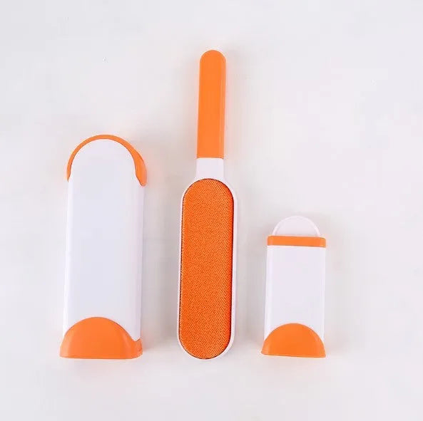 Blue reusable pet hair removal comb with double-sided brush head next to its self-cleaning base.