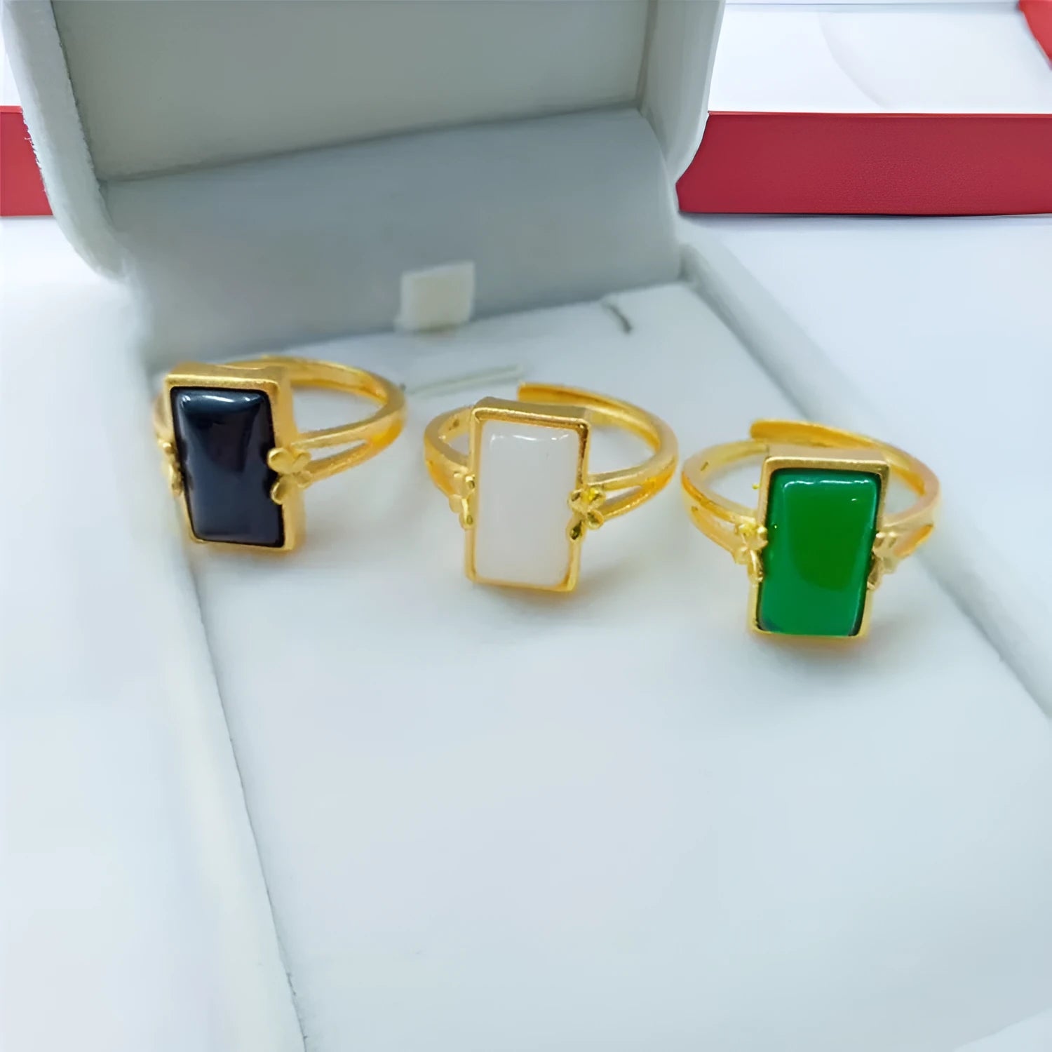 Adjustable brass gold-plated ring with gemstone in green, white or black options showing adjustable port mechanism