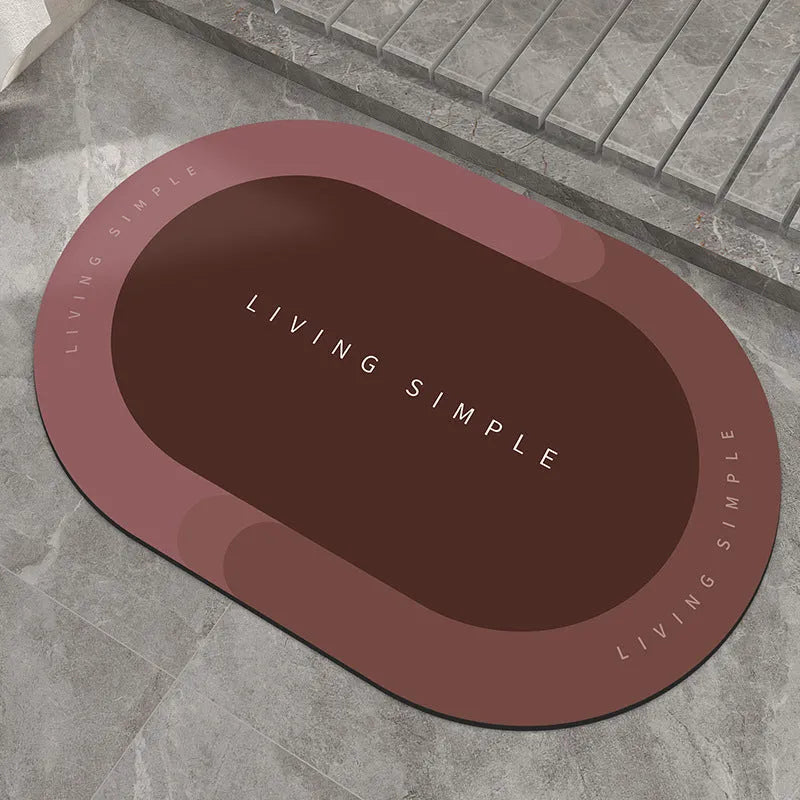Grey oval super absorbent polyester bath mat with non-slip rubber bottom on tiled floor