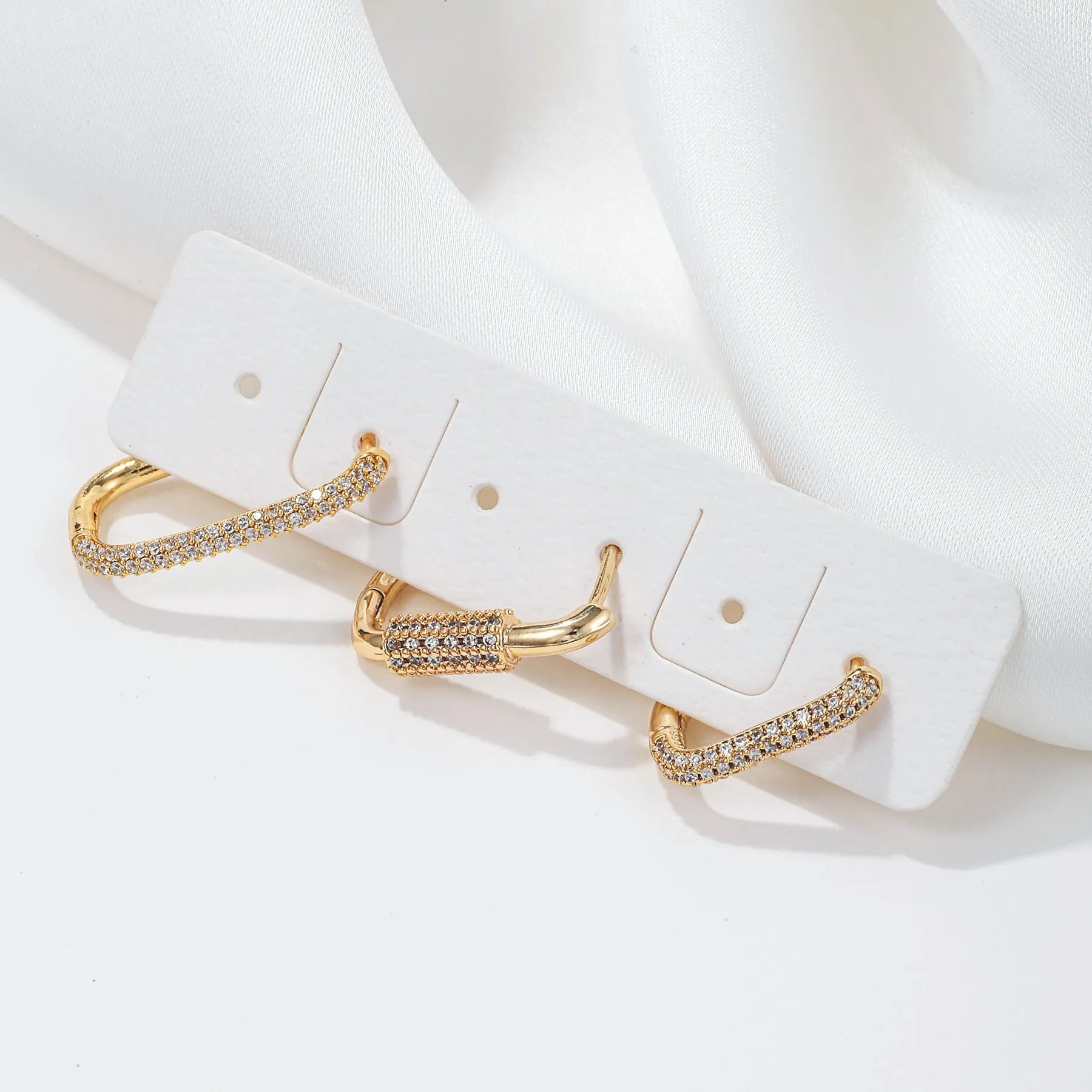 Copper geometric earring set with three square ear clips featuring inlaid zircon stones