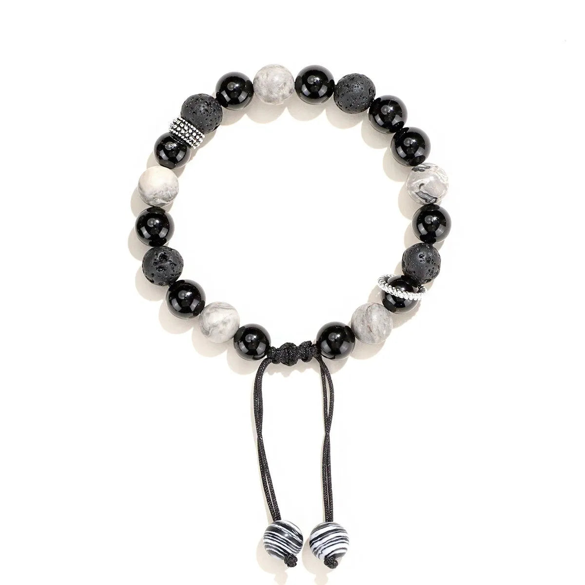 Black agate map stone and volcanic rock bracelet in diamond shape on a wrist.