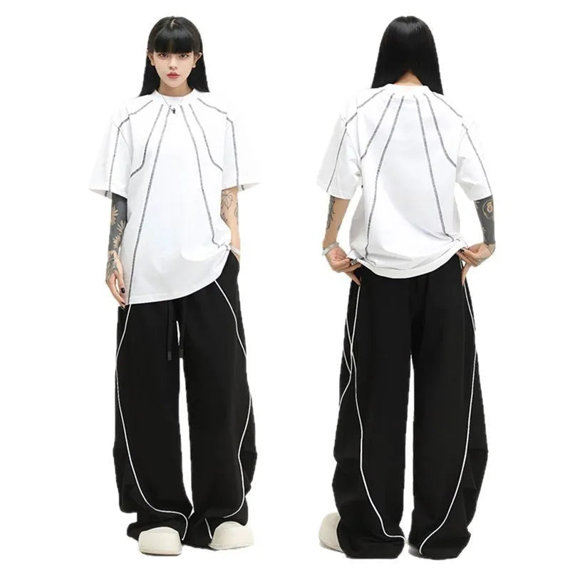 Black and white striped pleated wide-leg hip hop pants on a neutral background