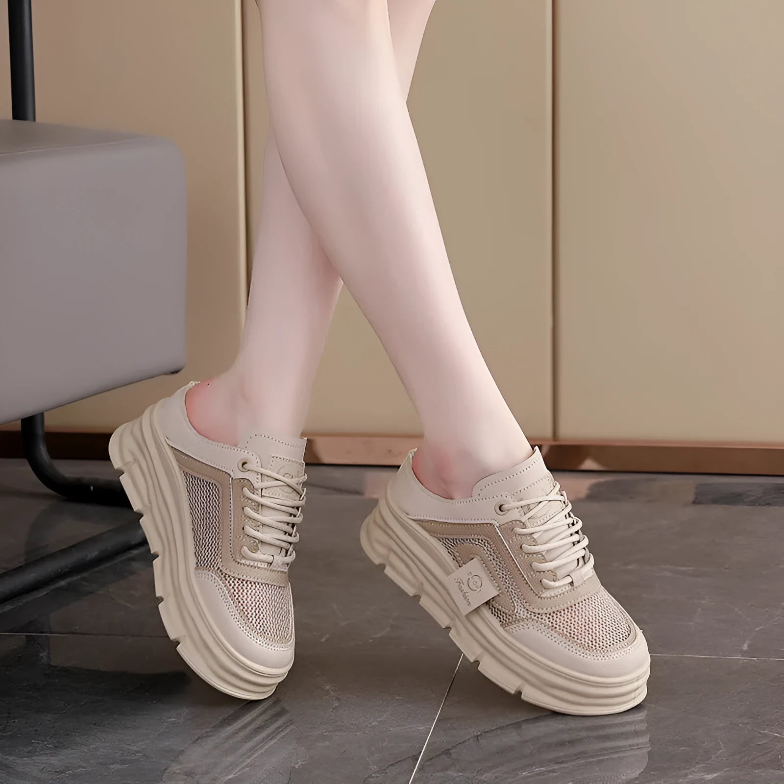 Women's black mesh half slippers with round toe and rubber sole, shown from the side.