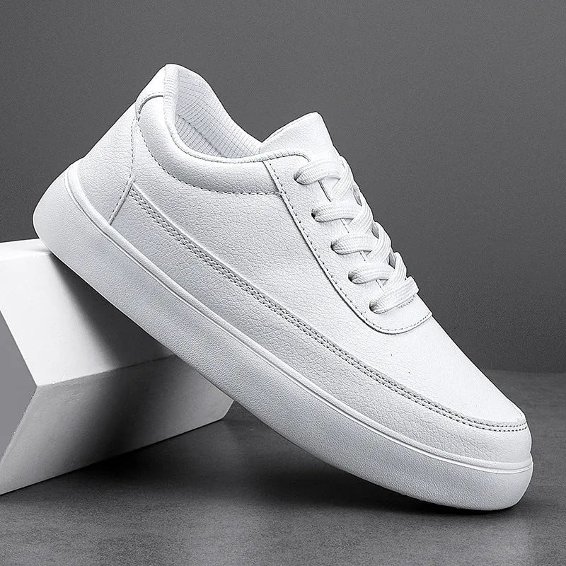 Women's white leather flat casual shoes with lace-up front on a plain background.