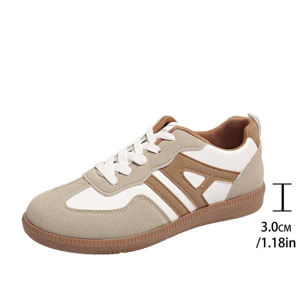 Women's retro grey jogging shoes with lace-up front and cross-strap detail on a rubber platform sole.