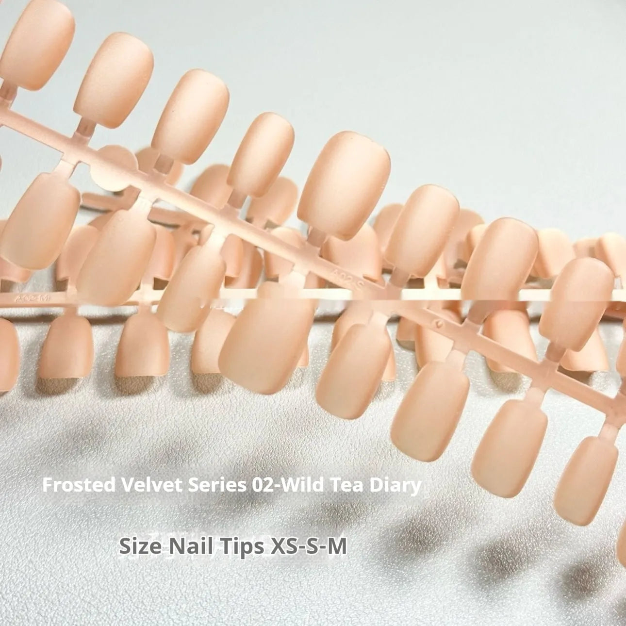False nails with frosty velvet cat's eye effect and aurora design in three short ladder sizes.
