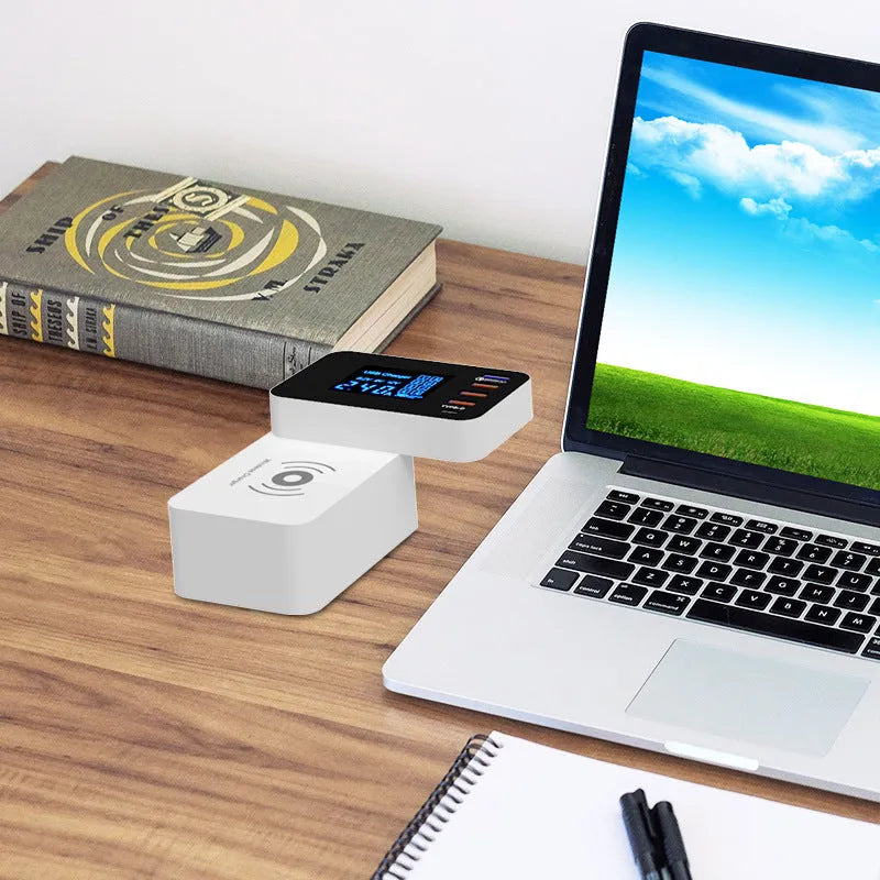 White multi USB port fast charger with wireless charging pad on top, showing four USB ports and UK plug adapter