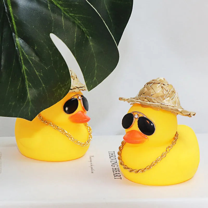 Yellow duck car dashboard ornament with straw hat, matte finish, and included adhesive base with sunglasses necklace