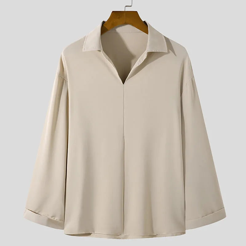 Man wearing a loose fit, solid colour, long sleeve casual shirt suitable for business.