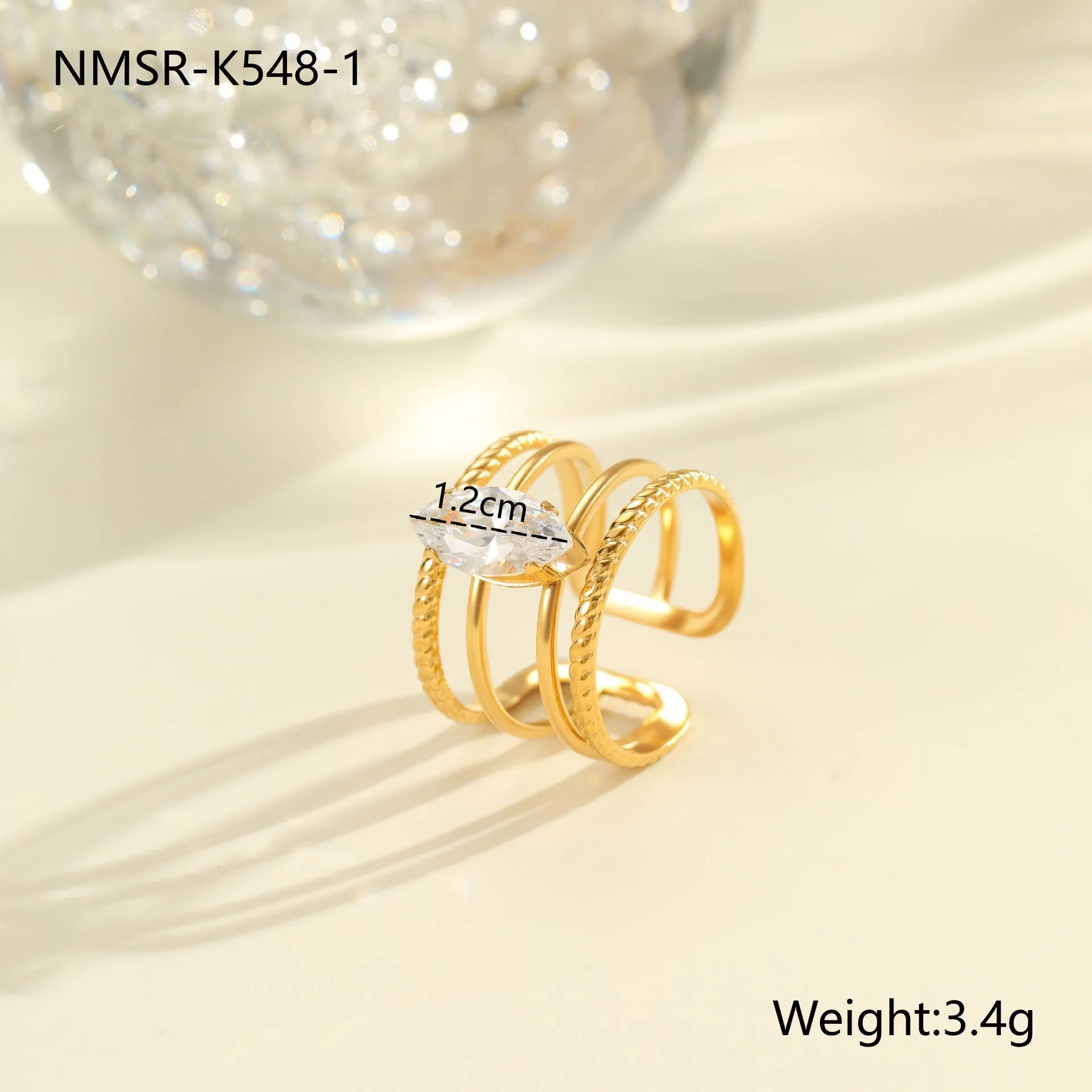 Gold-plated geometric stainless steel ring with inlaid zircon stones on a white background.