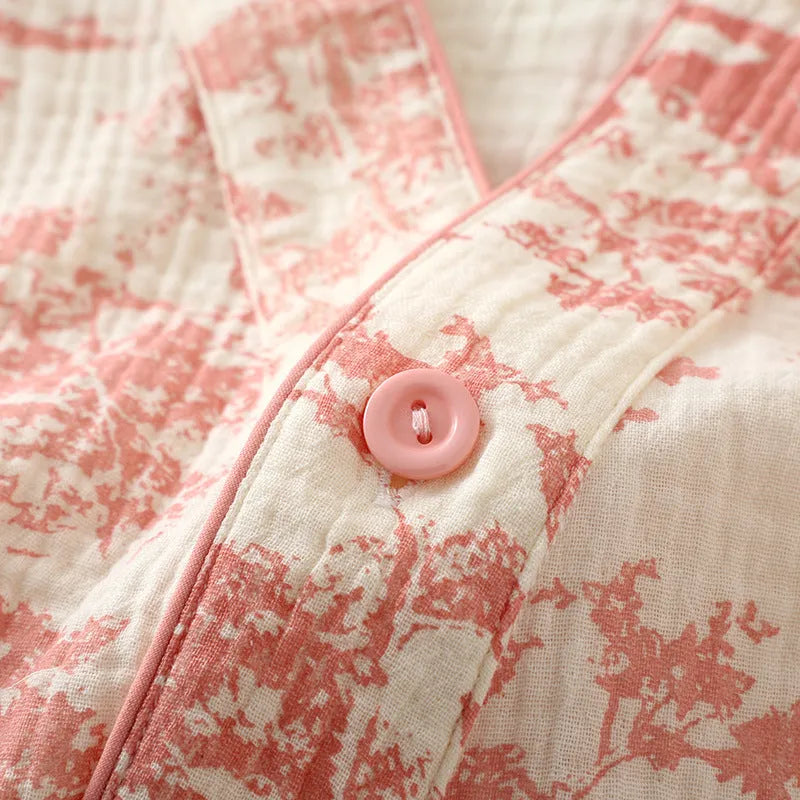 Women's pink cotton gauze long sleeve top and trousers matching loungewear set laid flat.