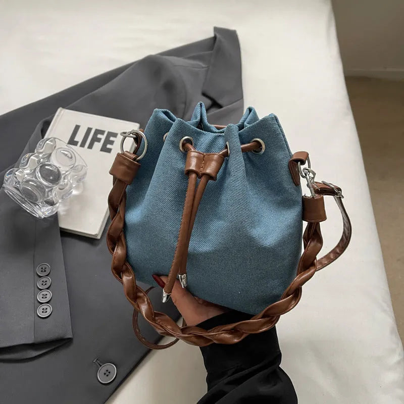 Blue cross body bucket messenger bag with synthetic leather construction