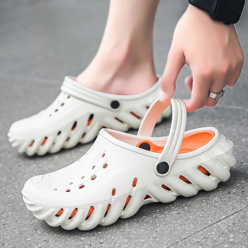 Men's beige EVA slipper sandals with hollow-out design and round toe holder on a plain background.