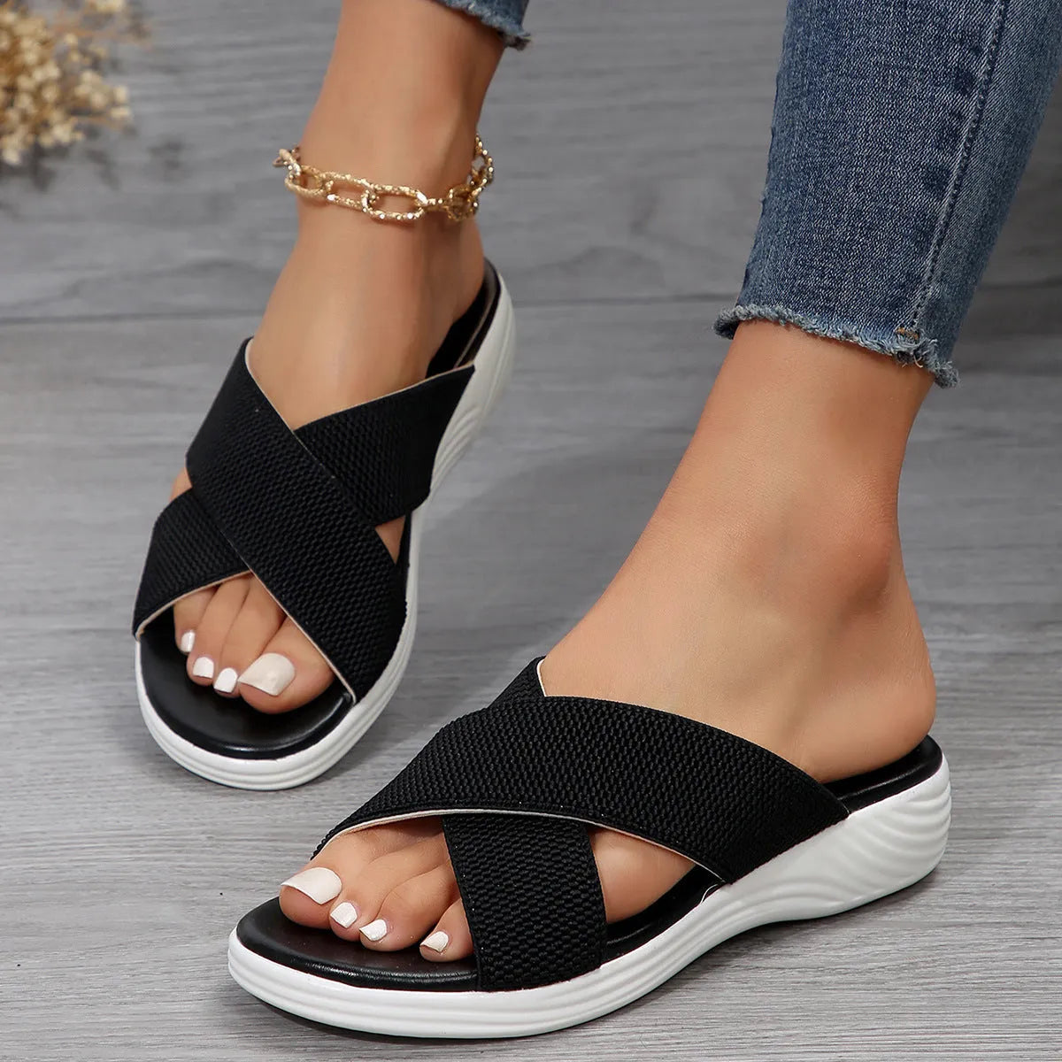 Women's black wedge slippers with peep-toe design and cross-strap PVC upper on thick rubber sole