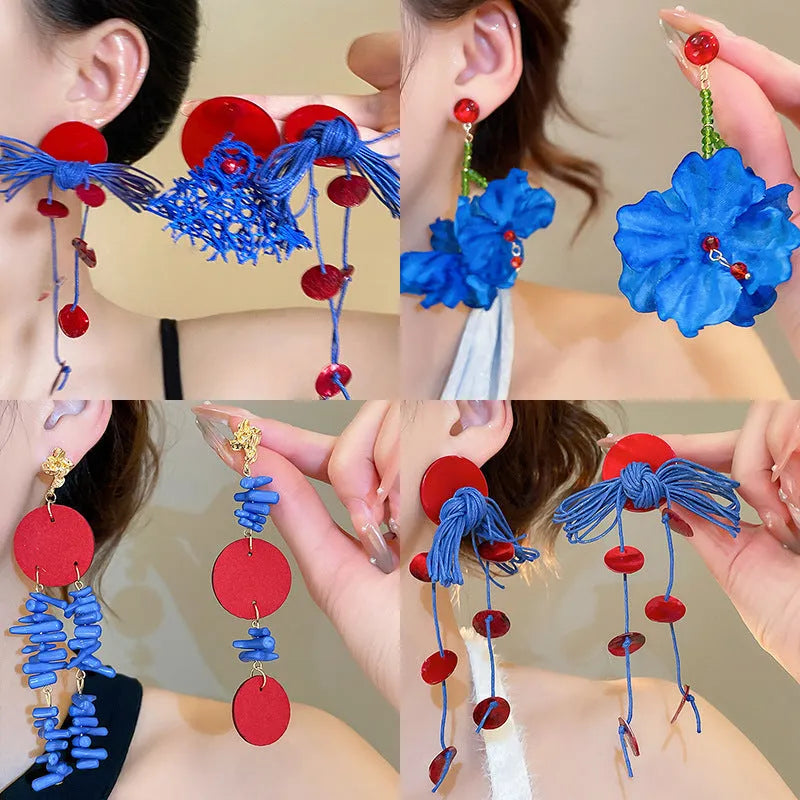 Blue geometric earrings with resin flower detailing and cloth material construction