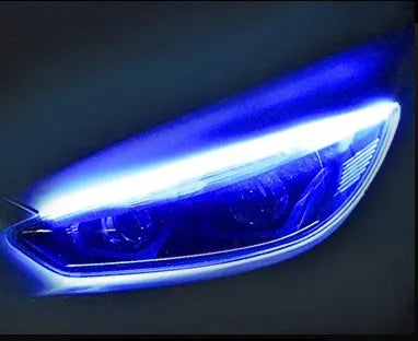 Flexible silicone car LED daytime running light strip with flowing turn signal animation mounted on headlight.