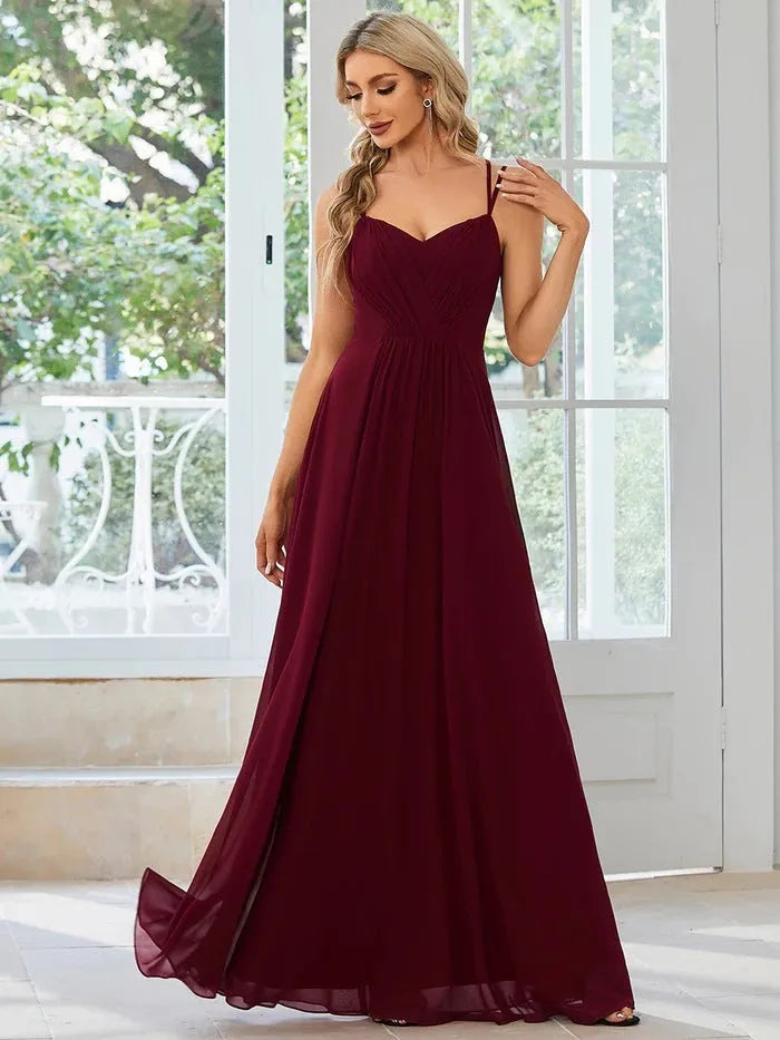 Women's light green sleeveless A-line banquet dress with long pleated skirt on a hanger.