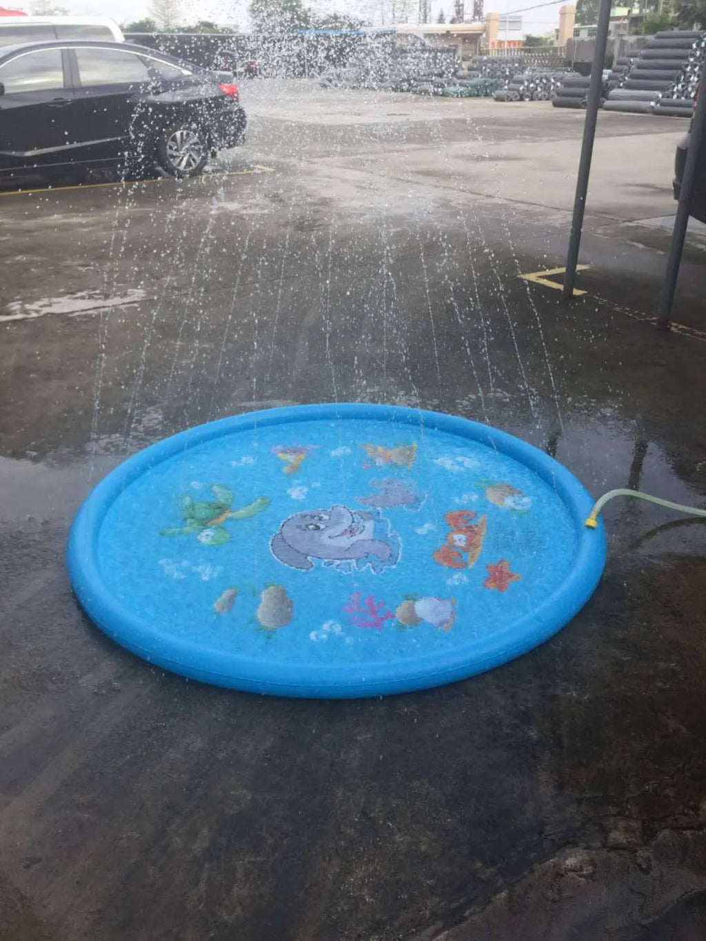Blue PVC children's water spray play mat with marine animal designs for outdoor garden use