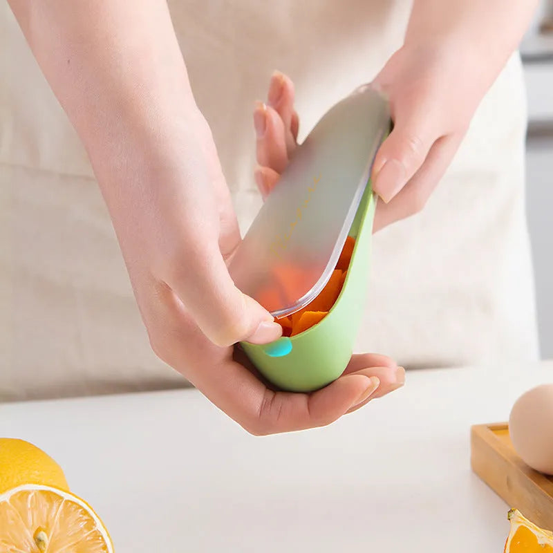 Dark green kitchen peeler with storage tube showing stainless steel blade and hangable handle