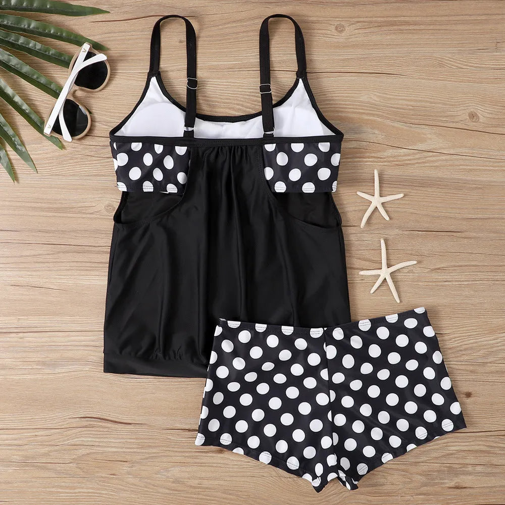 Women's black polka dot high-waist swimsuit with conservative briefs style on a mannequin.