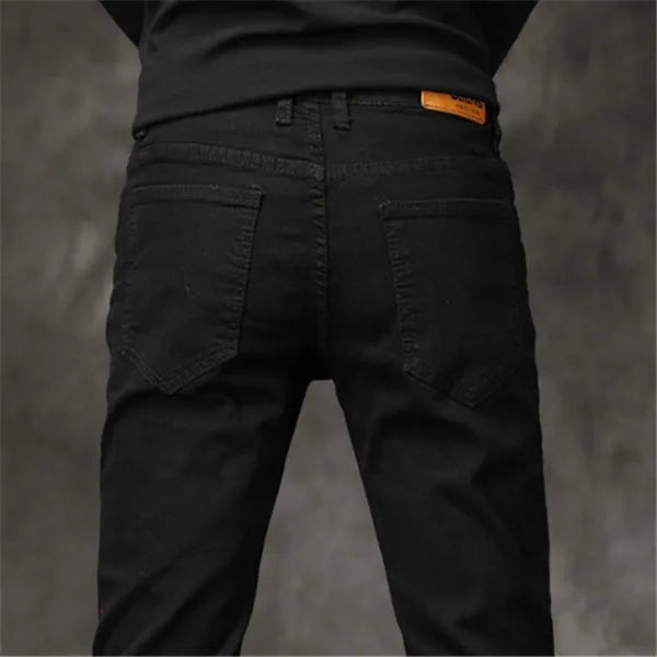 Slim-fit stretch cotton men's pants in black, laid flat showing tight cut and full length