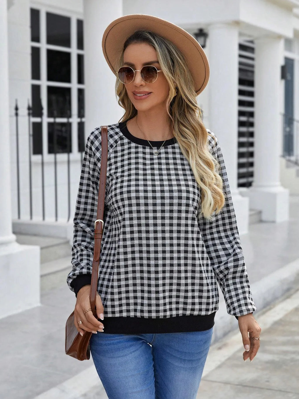 Black long sleeve pullover sweater with printed plaid and stripe pattern.