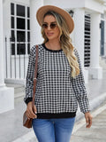 Black long sleeve pullover sweater with printed plaid and stripe pattern.